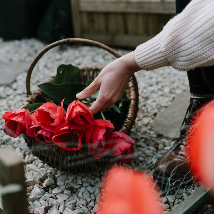 Maritime PR and communications - Woman in high vis holding a microphone between her and the male interviewee. both with their heads turned towards the rail track in the background
