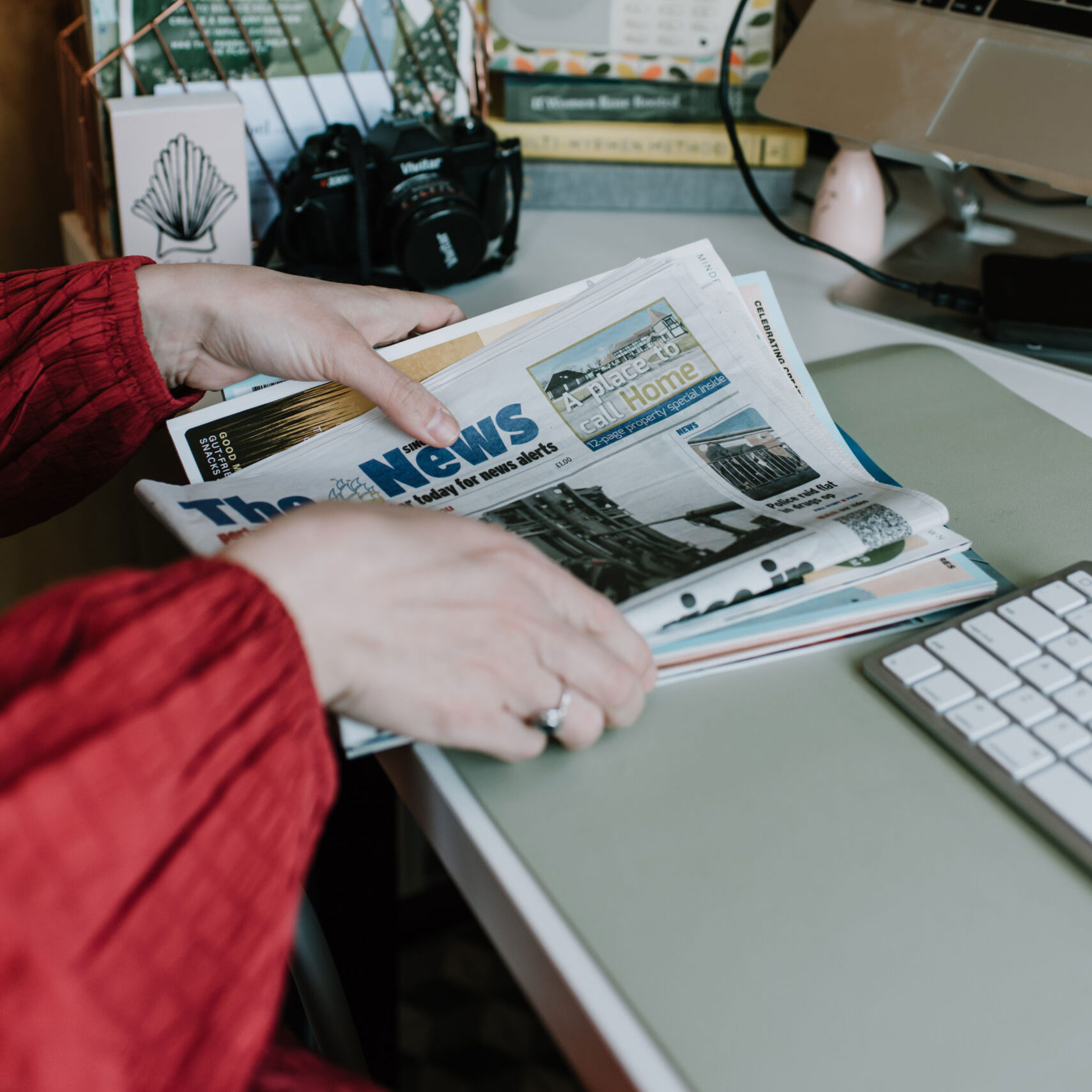 Maritime PR and communications - Woman in high vis holding a microphone between her and the male interviewee. both with their heads turned towards the rail track in the background