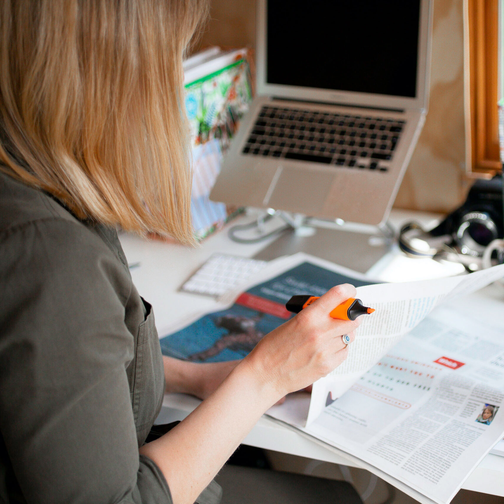 Maritime PR and communications - Woman in high vis holding a microphone between her and the male interviewee. both with their heads turned towards the rail track in the background
